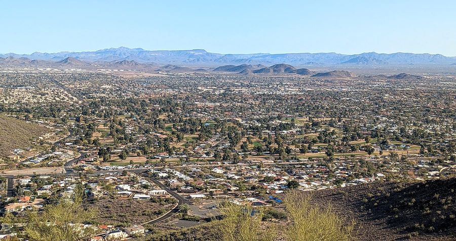 Moon Valley homes, streets and golf course seen from Lookout Mountain, with mountains on the horizon